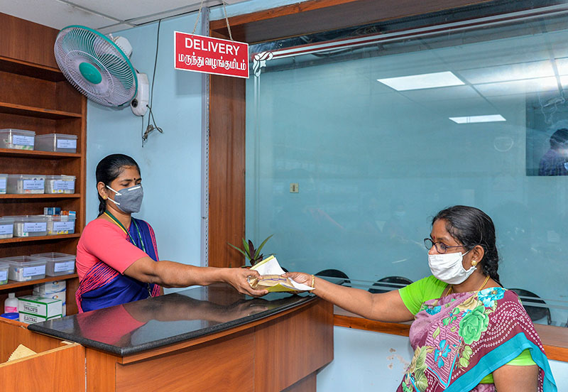 A patient receiving a prescription from a pharmacist