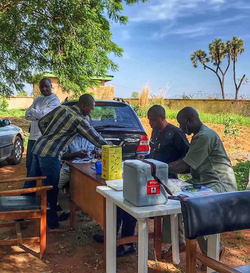 Team sitting at tables in a rural community setting
