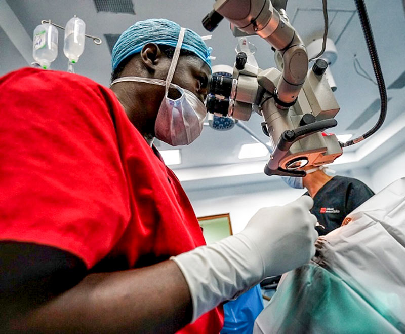 Surgeon operating with microscope