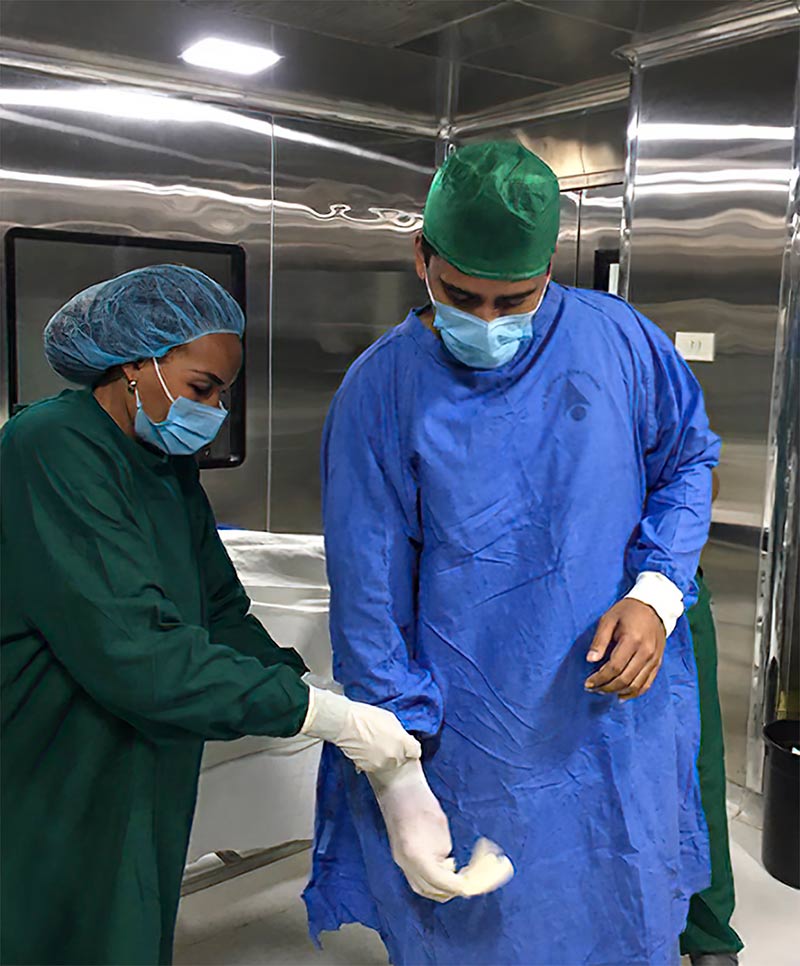 Nurse and doctor wearing scrubs in a n operating theatre