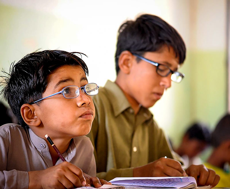 Two boys working in class